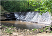Waterfall Cascading down Steep Steps in a Park